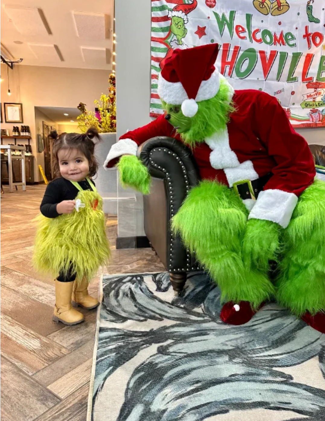 A grumpy green character raising a green holiday cocktail